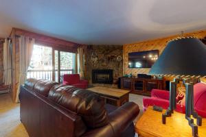 a living room with a leather couch and a table at Phoenix I in Steamboat Springs +7 photos
