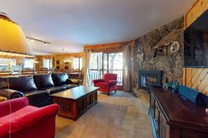 a living room with a couch and a fireplace at Phoenix I in Steamboat Springs