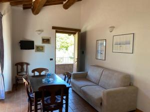 a living room with a couch and a table at Podere La Tona in Gavorrano