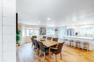a kitchen and dining room with a wooden table and chairs at The Chinook House in Depoe Bay