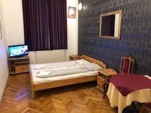 a bedroom with a bed and a tv in it at Apartman 4 YOU 2. in Budapest
