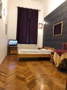 a bedroom with a bed and a tv in it at Apartman 4 YOU 2. in Budapest