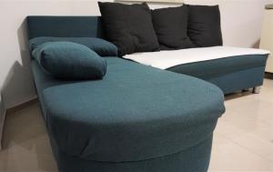 a blue couch sitting in a living room at Apartmani Zaric in Malinska +64 photos