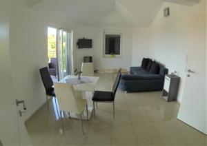 a living room with a table and a couch at Apartmani Zaric in Malinska