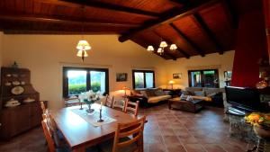 a living room with a wooden table and a living room at Can Castell de Rocabruna in Camprodon