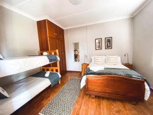 a bedroom with two bunk beds and a rug at Wiida Gasteplaas in Hopetown +79 photos