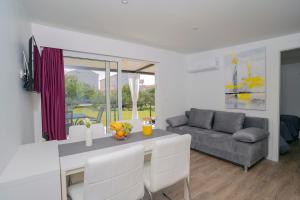 a living room with a table and a couch at Adriatic Mobile Homes in Sveti Filip i Jakov
