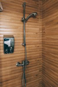 a shower with a hose attached to a wooden wall at Alcázar de María in Seville