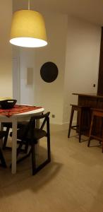 a room with a table and chairs and a light at Beautiful Infante Apartment in Porto +8 photos