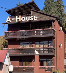 a house with a sign on the side of it at Amosov's House in Adler