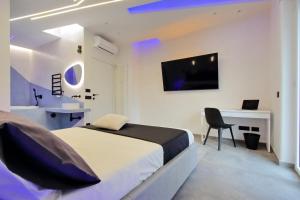 a bedroom with a bed and a desk and a television at Luxury SPA Apartment in Rome