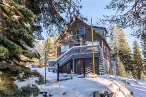 a log cabin in the woods in the snow at Hillside Haven in Soda Springs