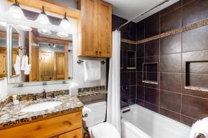 a bathroom with a sink and a tub and a shower at Chateau Studio in Breckenridge