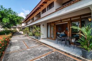 a patio of a house with a table and chairs at Flamingo Villa #12 in Playa Flamingo