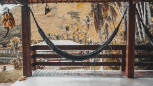 a hammock in a gazebo with a mural at Fazenda Lagoa Azul in Silva Jardim