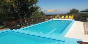 a large blue swimming pool next to a wooden fence at Corazon de Montaña in Merlo