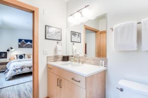 a bathroom with a sink and a toilet and a bed at Golden Poles Chalet #110 in Government Camp +30 photos