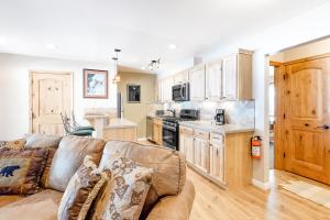 a living room with a couch and a kitchen at Wildernest in Stateline