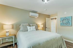 a bedroom with a bed and a night stand with two lamps at Liberty Bay Loft in Poulsbo