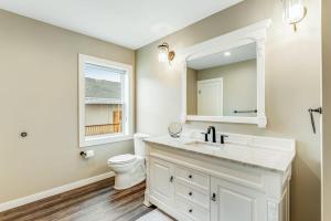 a white bathroom with a sink and a toilet at Liberty Bay Loft in Poulsbo +27 photos