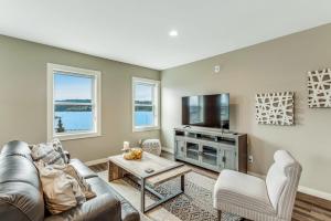 a living room with a couch and a tv at Liberty Bay Loft in Poulsbo