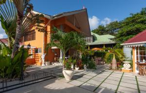 a courtyard of a building with trees and plants at Oceane Self Catering in La Digue