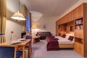 a hotel room with a bed and a living room at Hotel Aquamarin in Kühlungsborn