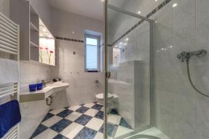 a bathroom with a shower and a toilet and a sink at Hotel Aquamarin in Kühlungsborn