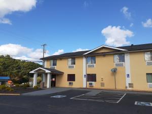 a large yellow building with a parking lot at Super 8 by Wyndham Farmville in Farmville