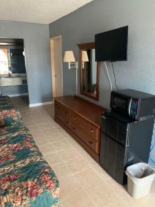 a hotel room with a bed and a television at Executive Inn Mercedes Weslaco in Mercedes