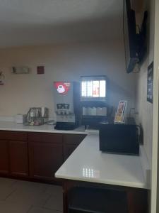 a kitchen with a white counter top and a window at Super 8 by Wyndham Farmville in Farmville