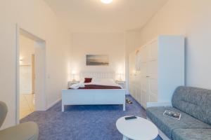 a living room with a bed and a couch at Hotel Aquamarin in Kühlungsborn