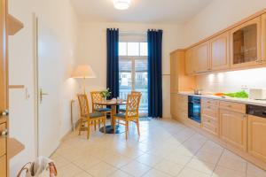 a kitchen with a table and chairs and a dining room at Hotel Aquamarin in Kühlungsborn