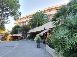 a building with a potted tree in front of it at Classy Apartment in Nice with pool and private parking place in Nice
