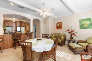 a dining room and living room with a table and chairs at Siesta Avenida Townhome 5208 in Siesta Key
