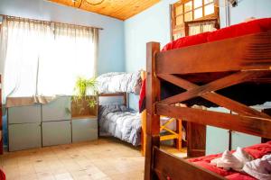 a room with two bunk beds and a window at Los 3 Gómez in Capilla del Monte