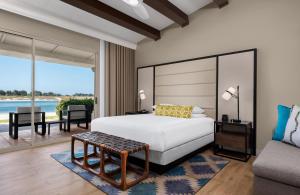 a bedroom with a bed and a living room at San Diego Mission Bay Resort in San Diego