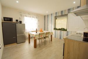 a kitchen with a table and a refrigerator at Mainzimmer - Business Apartments in Hasloch