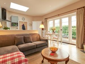 a living room with a couch and a table at East Lodge in Fordingbridge