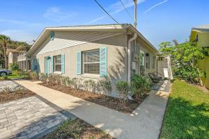 a house with a blue shutter on the side of it at Déjà Blue - Steps to the Ocean! in Saint Augustine