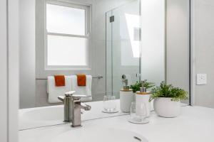 a bathroom with a sink and a mirror at The Terrace Penthouse Apartment in Brunswick Heads +17 photos