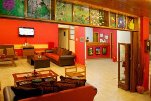 a living room with red walls and couches at Hotel Faraggi in Kleidoniá