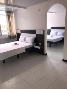 a room with two beds and a window at Gavan Plaza Hotel in Villavicencio