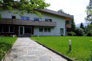 a house with a stone path in front of it at Lärchenhof in Afritz