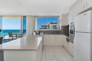 A kitchen or kitchenette at Golden Sands on the Beach - Absolute Beachfront Apartments