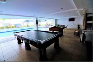 een pooltafel in een kamer met een zwembad bij Imperial Flat in João Pessoa