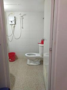 a bathroom with a toilet and a shower at Watermoon Beach Resort in Lian