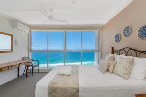 a bedroom with a bed with a view of the ocean at Golden Sands on the Beach - Absolute Beachfront Apartments in Gold Coast