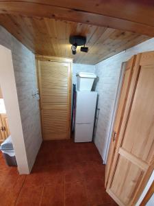 a hallway with a white refrigerator and a door at Mona Villa Holiday Home in Coulderton