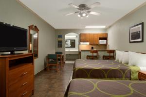 a hotel room with two beds and a flat screen tv at Super 8 by Wyndham South Padre Island in South Padre Island